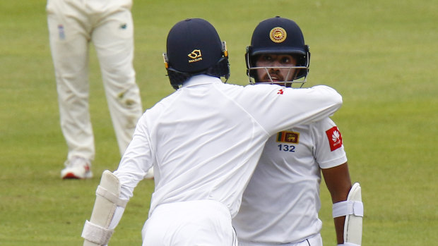 Sri Lanka's Oshada Fernando congratulates teammate Kusal Mendis on reaching his half-century.