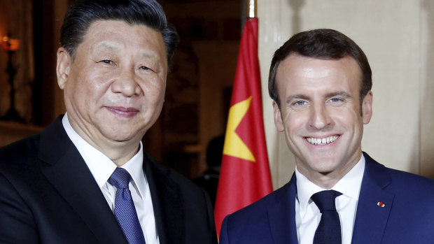 Chinese President Xi Jinping, left, is welcomed by French President Emmanuel Macron in Beaulieu-sur-Mer, southern France in 2019.