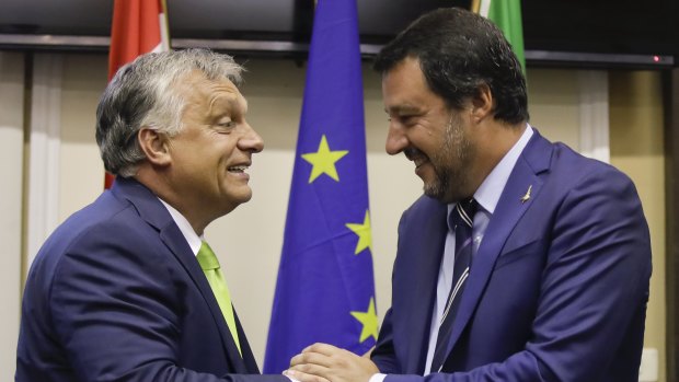 Italy's Interior Minister and Deputy-Premier Matteo Salvini, right, shakes hand with Hungary's Prime Minister Viktor Orban after their meeting in Milan, Italy.