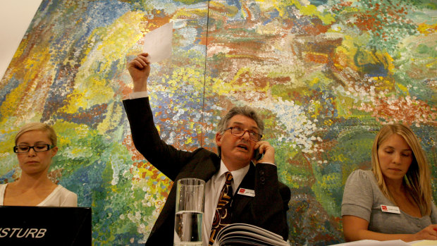 In the first groundbreaking auction for Emily Kame Kngwarreye's  Earth's Creation in 2007, Adrian Newstead of Lawson Menzies bids for a would-be phone buyer.