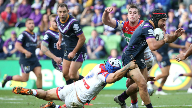 Purple reign: The Knight defence hang on to Jahrome Hughes at AAMI Park.