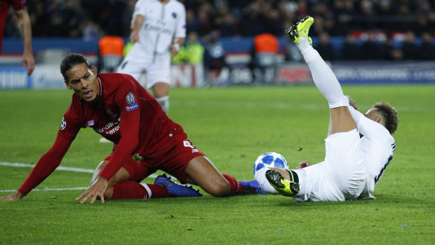 PSG forward Neymar (right) is brought down by a tackle by Liverpool's Virgil Van Dijk.