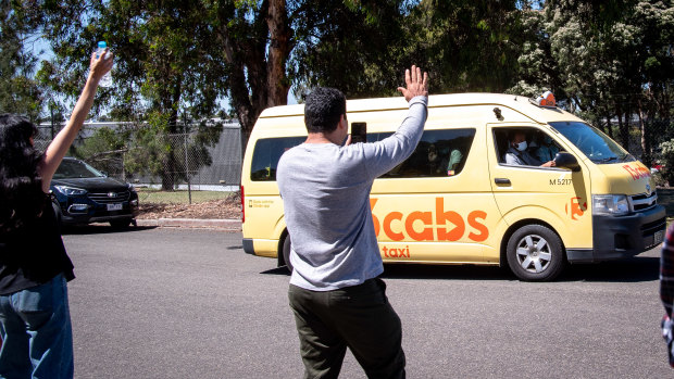 Refugee advocates wave to a van load of refugees leaving a detention centre in Broadmeadows on Wednesday.