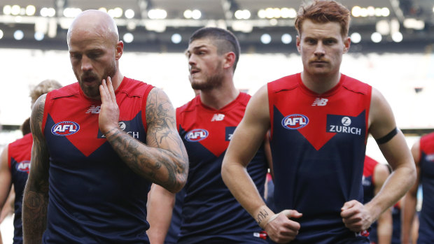 Nathan Jones (left) and the Demons head off the ground after the loss to Collingwood.