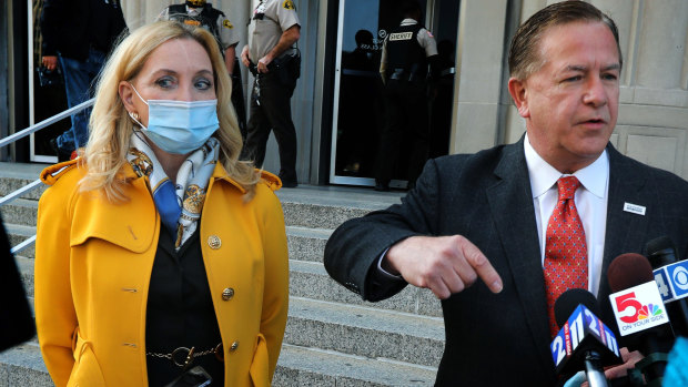 Mark McCloskey addresses the media  alongside his wife Patricia on Tuesday, outside the Carnahan Courthouse in St. Louis.