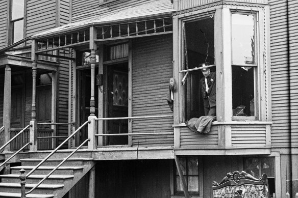 Police look through a broken window of a house during the race riots in Chicago. Hundreds of African Americans died at the hands of white mobs during “Red Summer” of 1919.