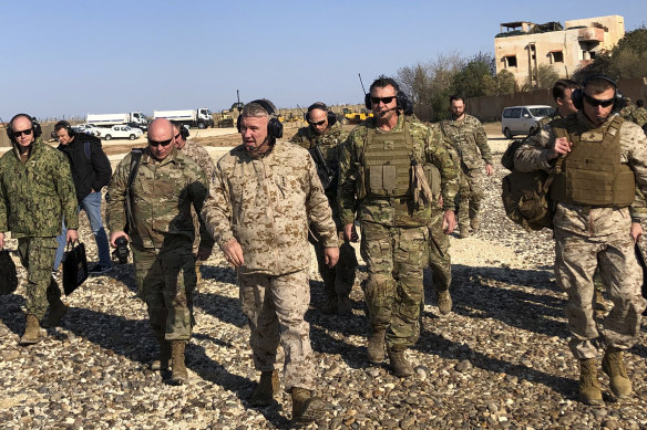 General Frank McKenzie (centre) the top US commander for the Middle East on Saturday, during an unannounced visit to military outposts in Syria. 
