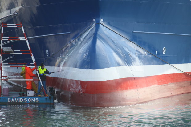 Workers clean Lunar Bow, one of the largest trawlers in Peterhead harbour.