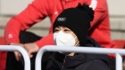 Chinese tennis player Peng Shuai watches the freestyle skiing at the Winter Olympics.