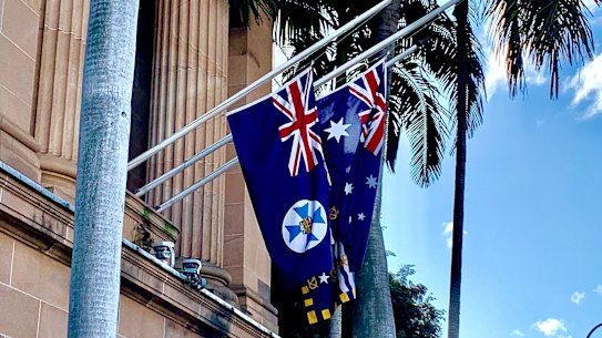 The Queensland flag, hanging at half mast alongide the Australian and Brisbane flags, on the day of Queen Elizabeth II’s death.