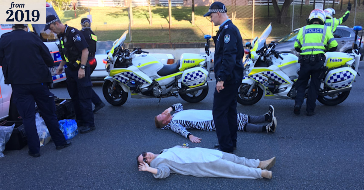 Two climate change activists glue themselves to Brisbane intersection