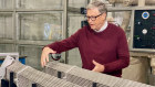 Bill Gates at TerraPower with a mock-up of metal fuel pin bundles for his planned SMR.