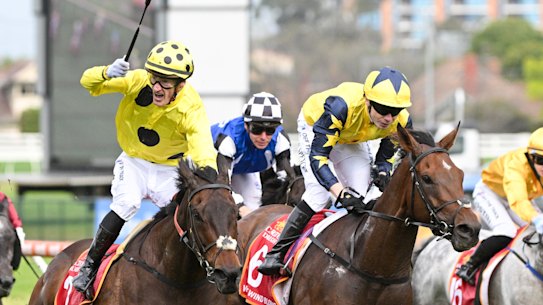 Mark Zahra (left) broke the whip rules on Without A Fight when beating just beating West Wind Blows (right) in the Caulfield Cup. 