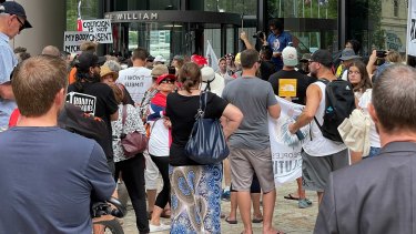 Hundreds of people protesting vaccination mandates have descended on 1 William Street after marching through the Brisbane CBD.