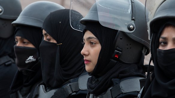 Pakistani police officers stand guard during a rally for International Women's Day in Islamabad, Pakistan.