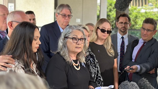 The families of Rachel McCrow and Matthew Arnold, led by Judy McCrow, outside Brisbane Magistrates Court after State Coroner Terry Ryan handed down his findings into the Wieambilla ambush.