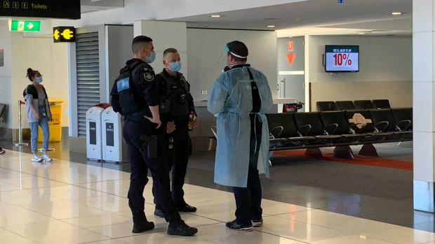 Authorised officers and Australian Federal Police at the Melbourne Airport on Saturday morning. 
