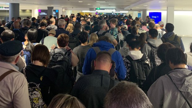 The arrivals queue at Sydney Airport's international terminal as waiting times stretched for 90 minutes after an IT systems outage affected all passengers departing or arriving in Australia.