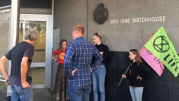 Protesters wait outside the Brisbane watchhouse for fellow activists to be released.