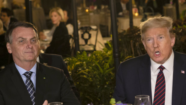 US President Donald Trump, right, and Brazilian President Jair Bolsonaro at Mar-a-Lago resort in Florida on Saturday.