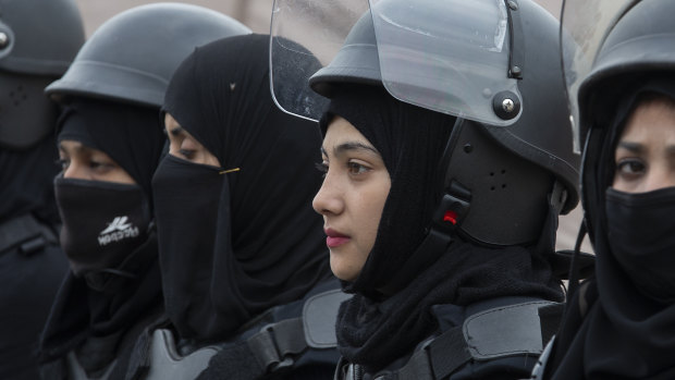 Pakistani police officers stand guard during a rally for International Women's Day in Islamabad, Pakistan.