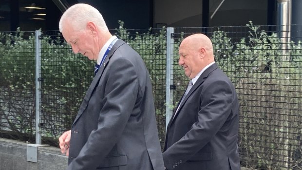 Retired Sergeant Peter Jenkins (right) leaves Toowoomba Magistrates Court on Thursday afternoon.