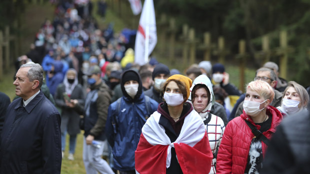 People go to the Kuropaty mass grave site of Soviet-era mass executions during an opposition rally to protest the official presidential election results in Minsk, Belarus.