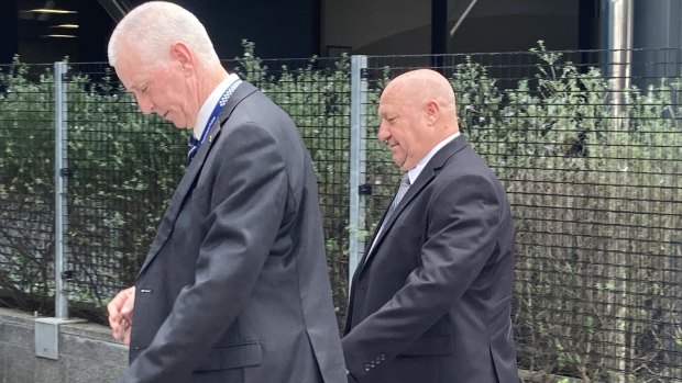 Retired Sergeant Peter Jenkins (right) leaves Toowoomba Magistrates Court on Thursday afternoon.