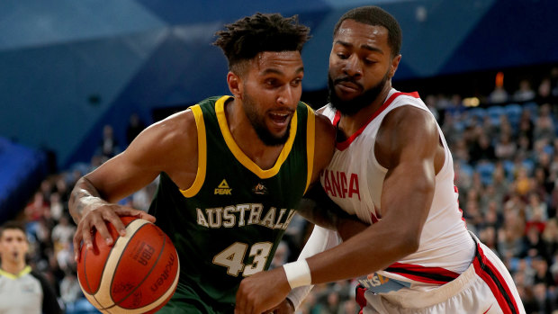 Boomer Jonah Bolden drives past Duane Notice during the first Australia v Canada match at RAC Arena in Perth.