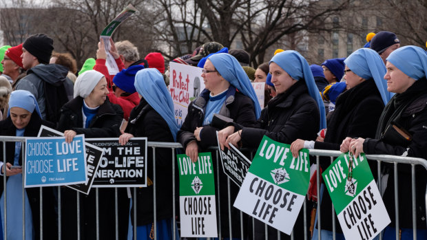 Nuns hold signs during the March for Life 2020 rally in Washington.