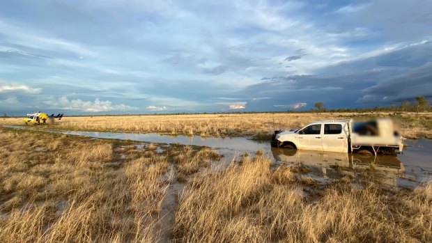 The bogged ute and RACQ LifeFlight Rescue helicopter, west of Mount Isa.