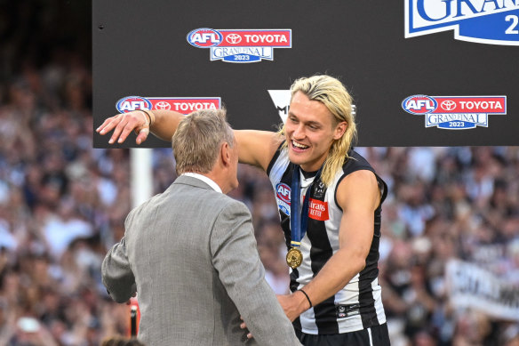 Darcy Moore embraces his father, Peter, after Collingwood’s big win.