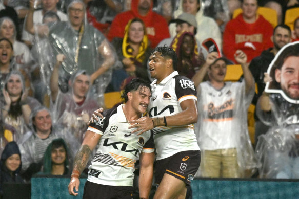 Kotoni Staggs and Selwyn Cobbo celebrate the former’s try for the Broncos against the Dolphins on Friday night.