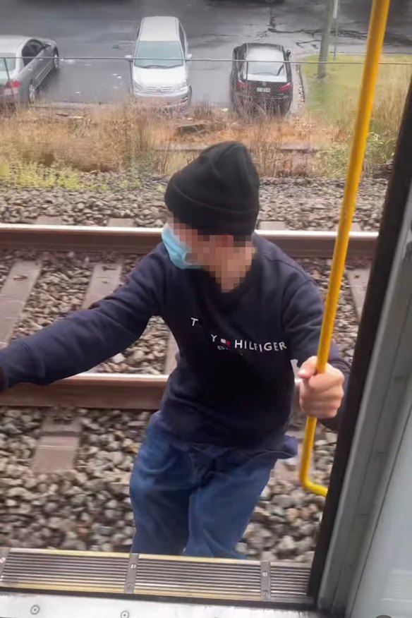 A teenager hangs from a Sydney train in a video posted on Instagram. 