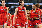 Suns players leave the field after the Carlton loss.