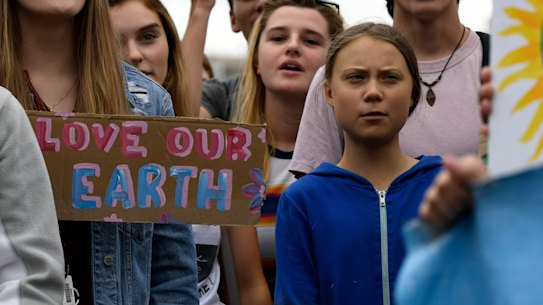 Greta Thunberg, centre in blue, joins other young climate activists Friday for a climate strike outside the White House in Washington on Friday.