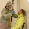 A person is tested for COVID-19 in a mobile testing site in Berlin Germany this week.