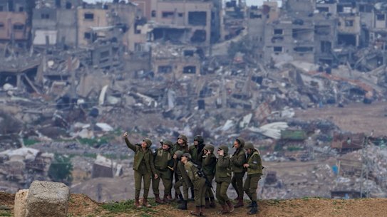 Israeli female soldiers pose for a photo on a position on the Gaza Strip border, in southern Israel, on Monday.