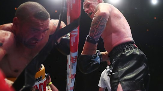 John Wayne-Parr fight punches  Anthony Mundine out of the ring.