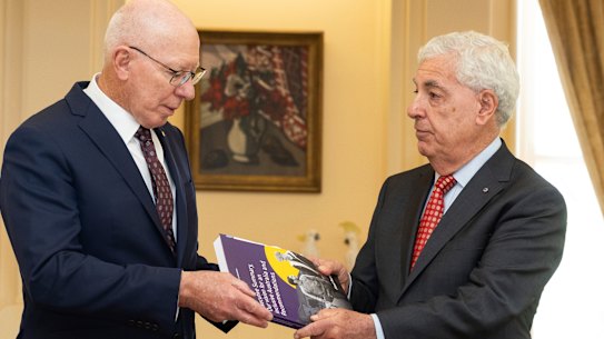 Governor-General David Hurley (left) receives the final report by the Royal Commission into Violence, Abuse, Neglect and Exploitation of People with Disability from Ronald Sackville on Thursday.