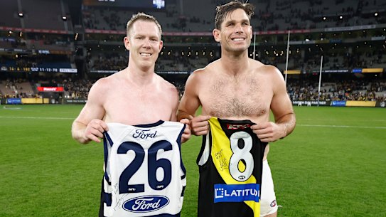 Tiger Jack Riewoldt and Cat Tom Hawkins with each other’s guernseys after Friday night’s match.
