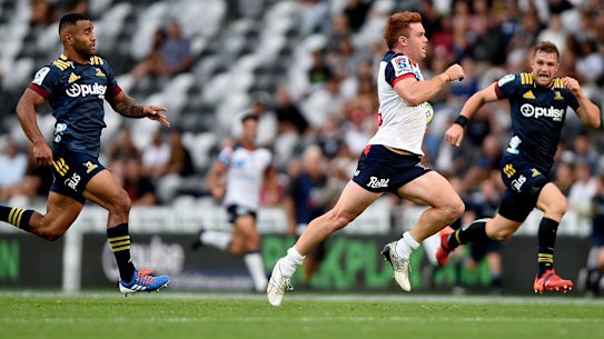 Andrew Kellaway races away to score one of his two tries for the Rebels against the Highlanders.