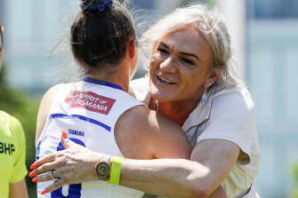 Dani Laidley (right) hugs North Melbourne captain Emma Kearney before an AFLW game in January.