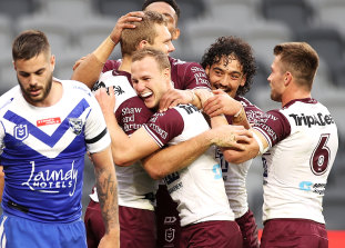 Tom Trbojevic celebrates one of his three tries with Sea Eagles teammates.