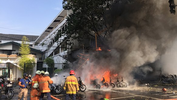 Firefighters try to extinguish a blaze following a blast at the Pentecost Church Central Surabaya (GPPS) in Surabaya.