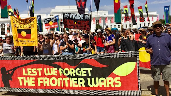 Invasion Day protesters arrive at the Aboriginal Tent Embassy opposite Old Parliament House on Saturday.