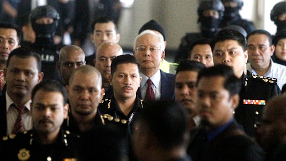 Najib Razak walks into a courtroom in Kuala Lumpur, Malaysia where he was charged with corruption offences.
