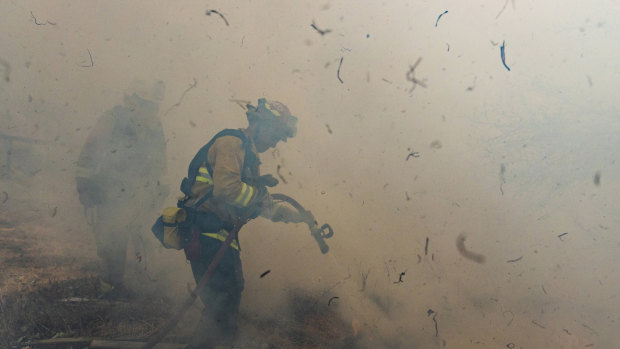 Firefighters work to extinguish flames from the Kincade Fire in Sonoma County, California on Sunday, October 27.