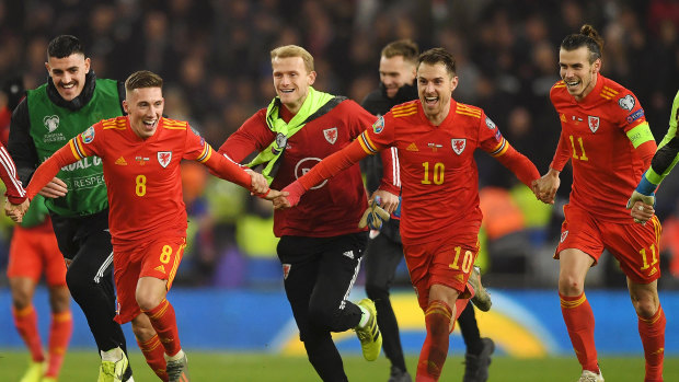 Harry Wilson, Ramsey and Gareth Bale react after securing direct qualification.