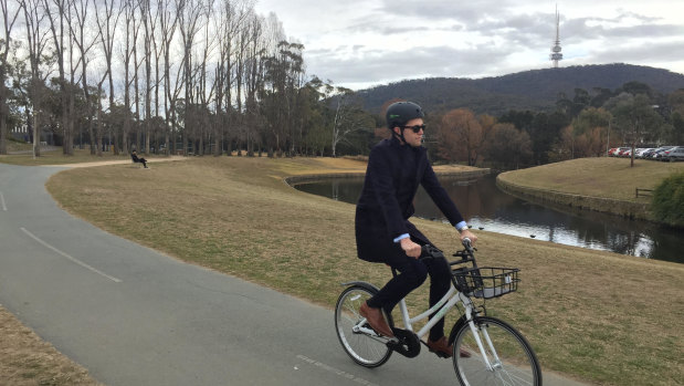 ANU student Samuel Bashfield tries out one of the Airbikes along Sullivans Creek
